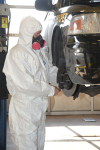 Motor Vehicle Division mechanic performing brake inspection on vehicle